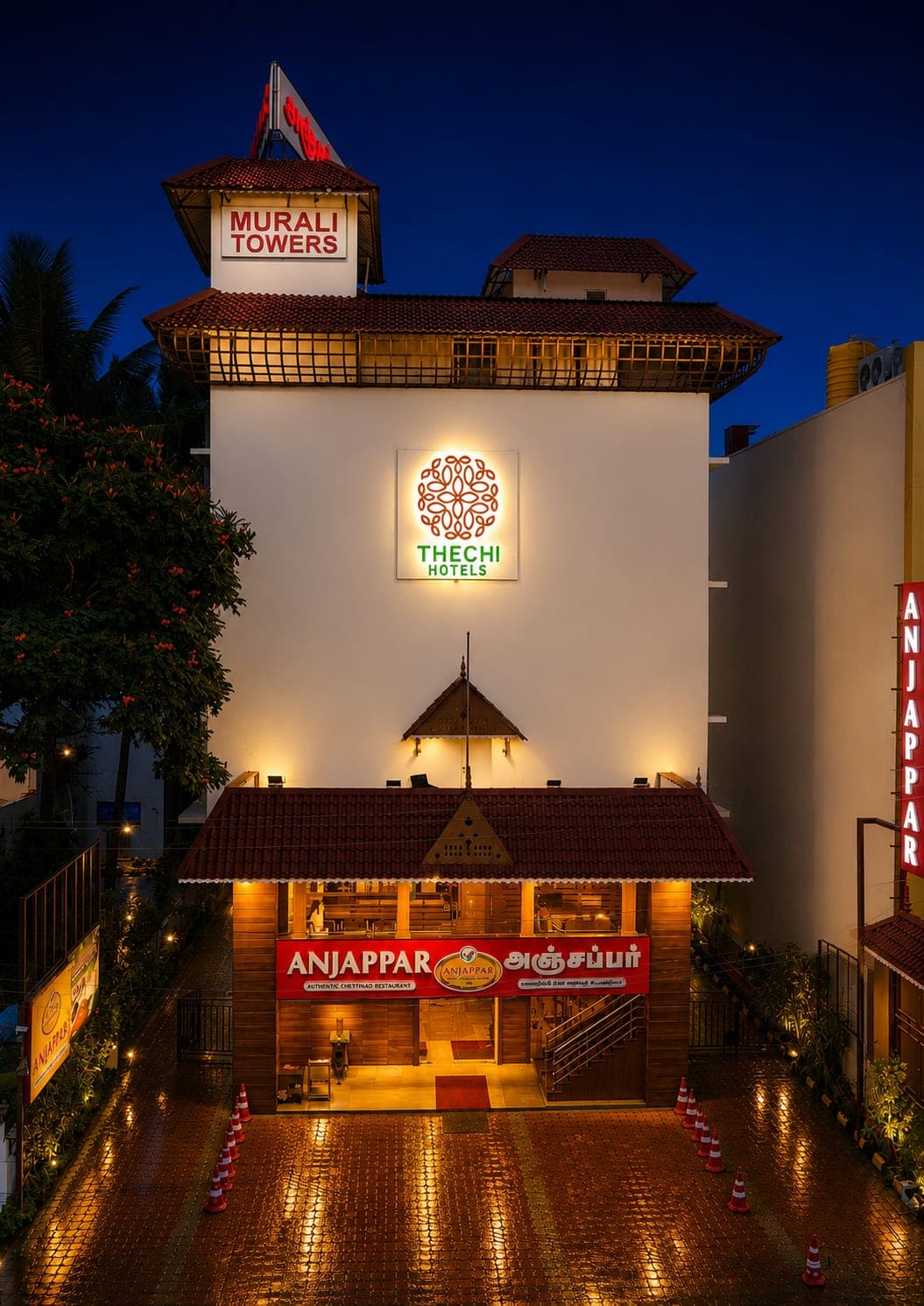 Thechi Hotel, Hosur — illuminated exterior at dusk on NH-44